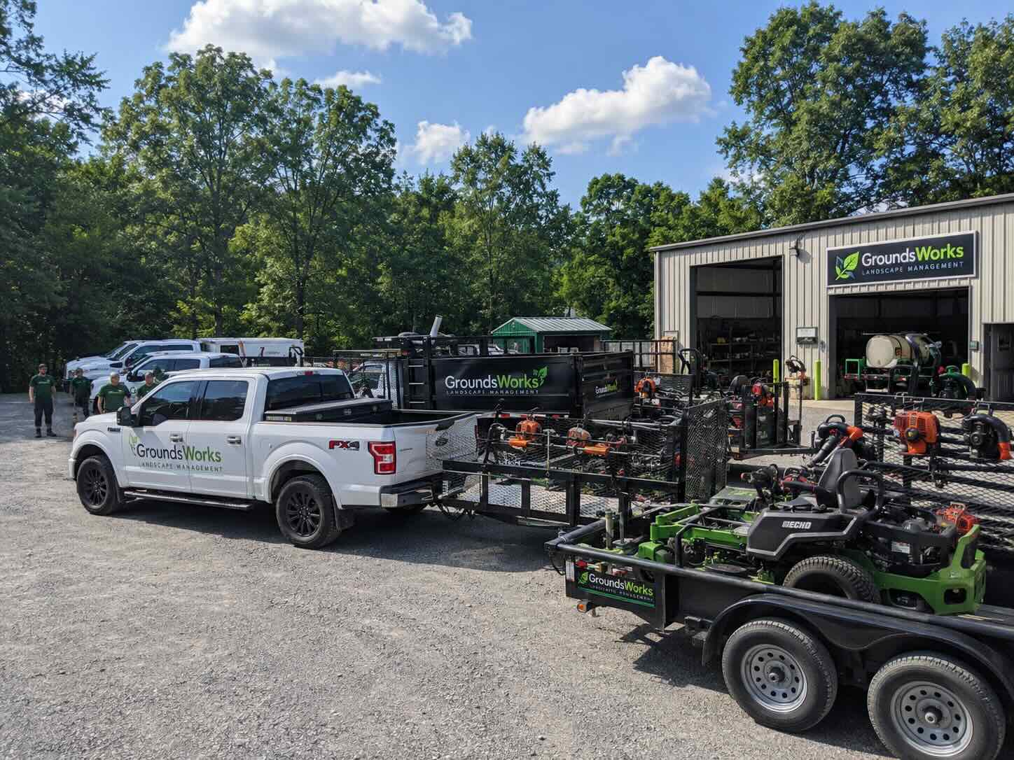 Fleet management for landscaping companies in action — landscaping fleet staged in yard with mowers visible