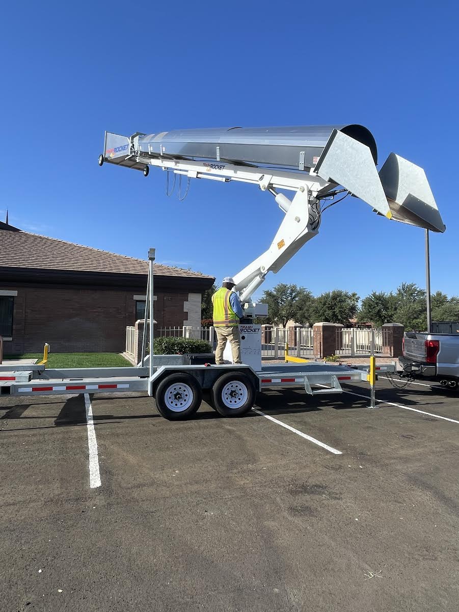 Trash Rocket debris chute trailer at a commercial roofing client site, GPS tracking installed by LBC Fleet