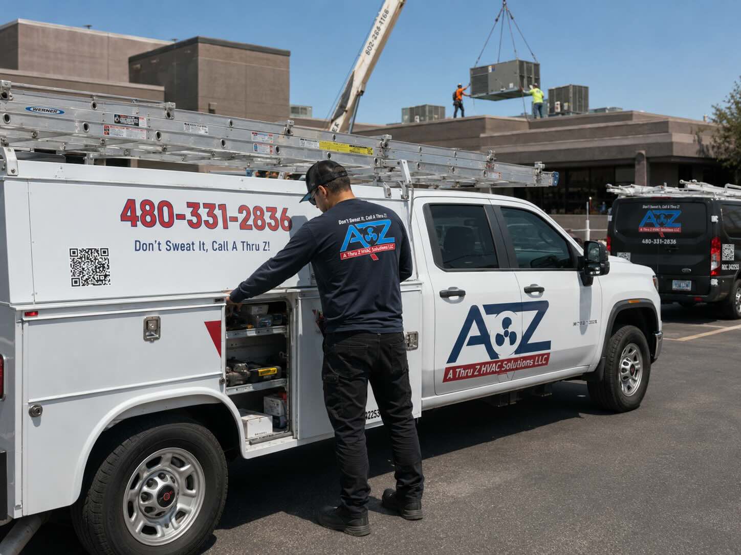 HVAC technician retrieving supplies from service truck during a customer call
