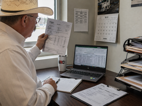 Mechanic reviewing a repair estimate as part of outsourced fleet maintenance management